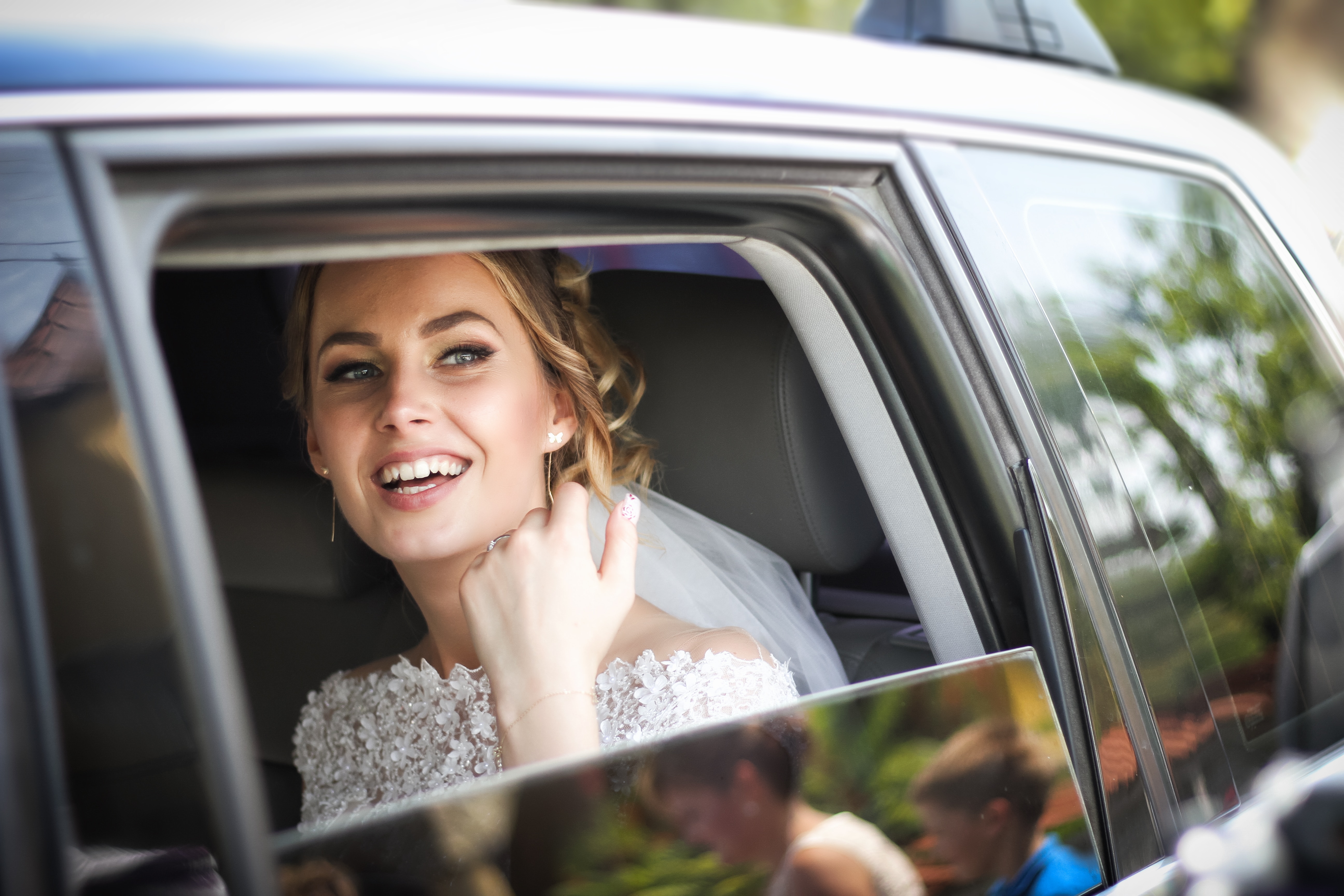 A happy looking bride in a car - Spring bride