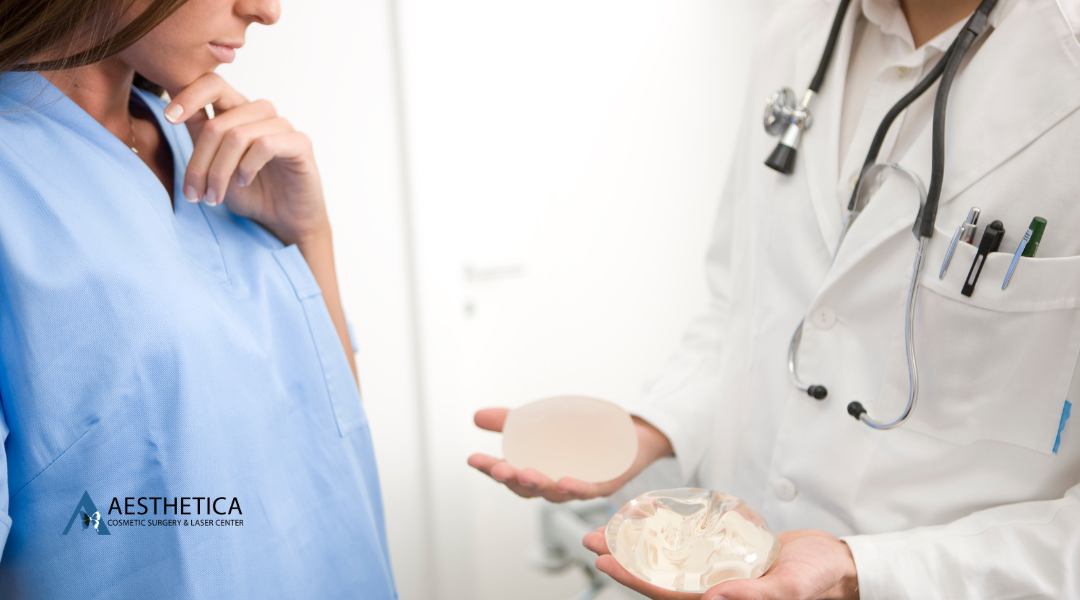 Doctor showing breast implant options to patient